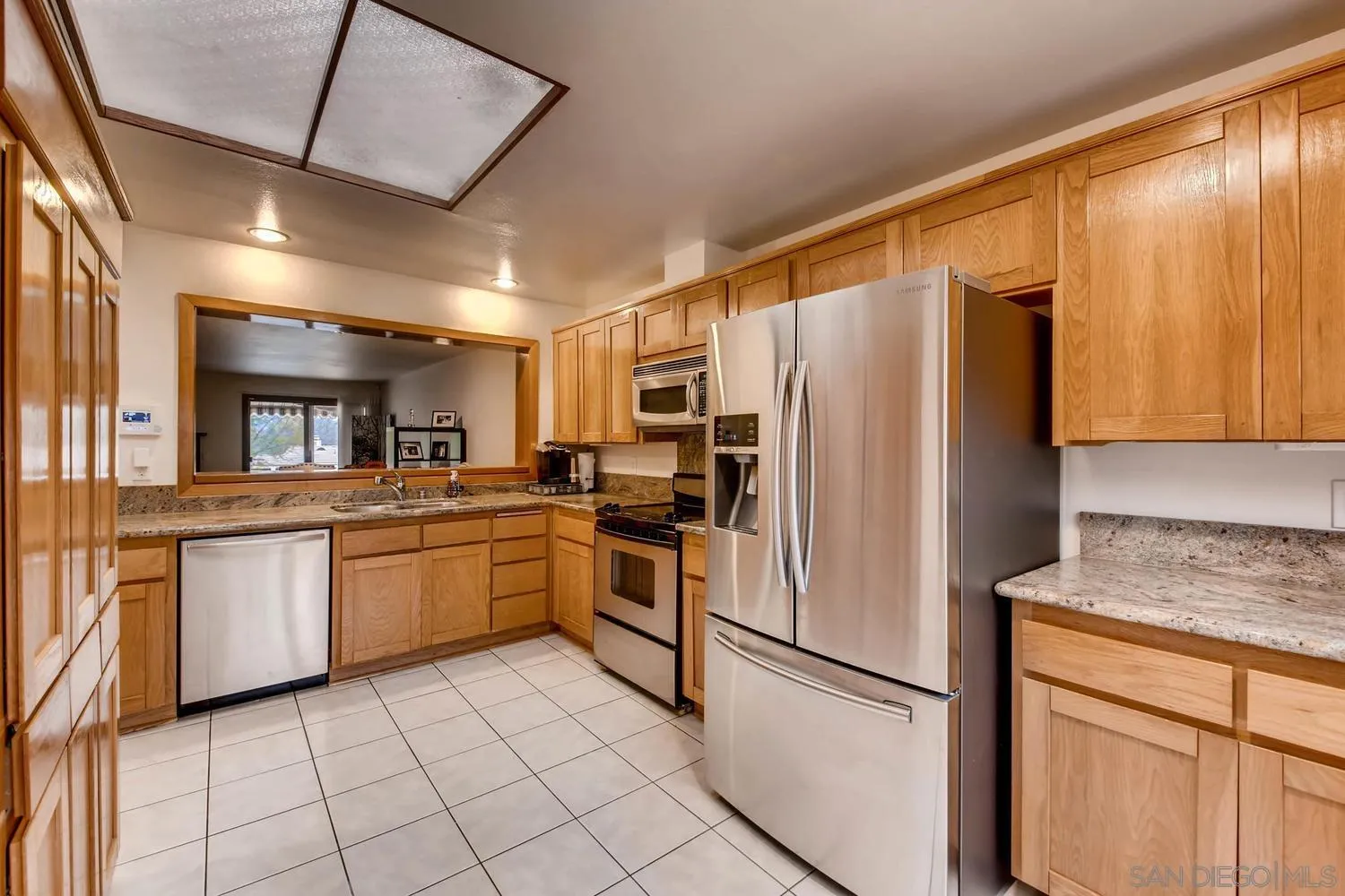 8525 Circle R Course Lane Escondido, CA 92026 - Photo 4 of 13 a kitchen with granite countertop stainless steel appliances a refrigerator a sink and cabinets