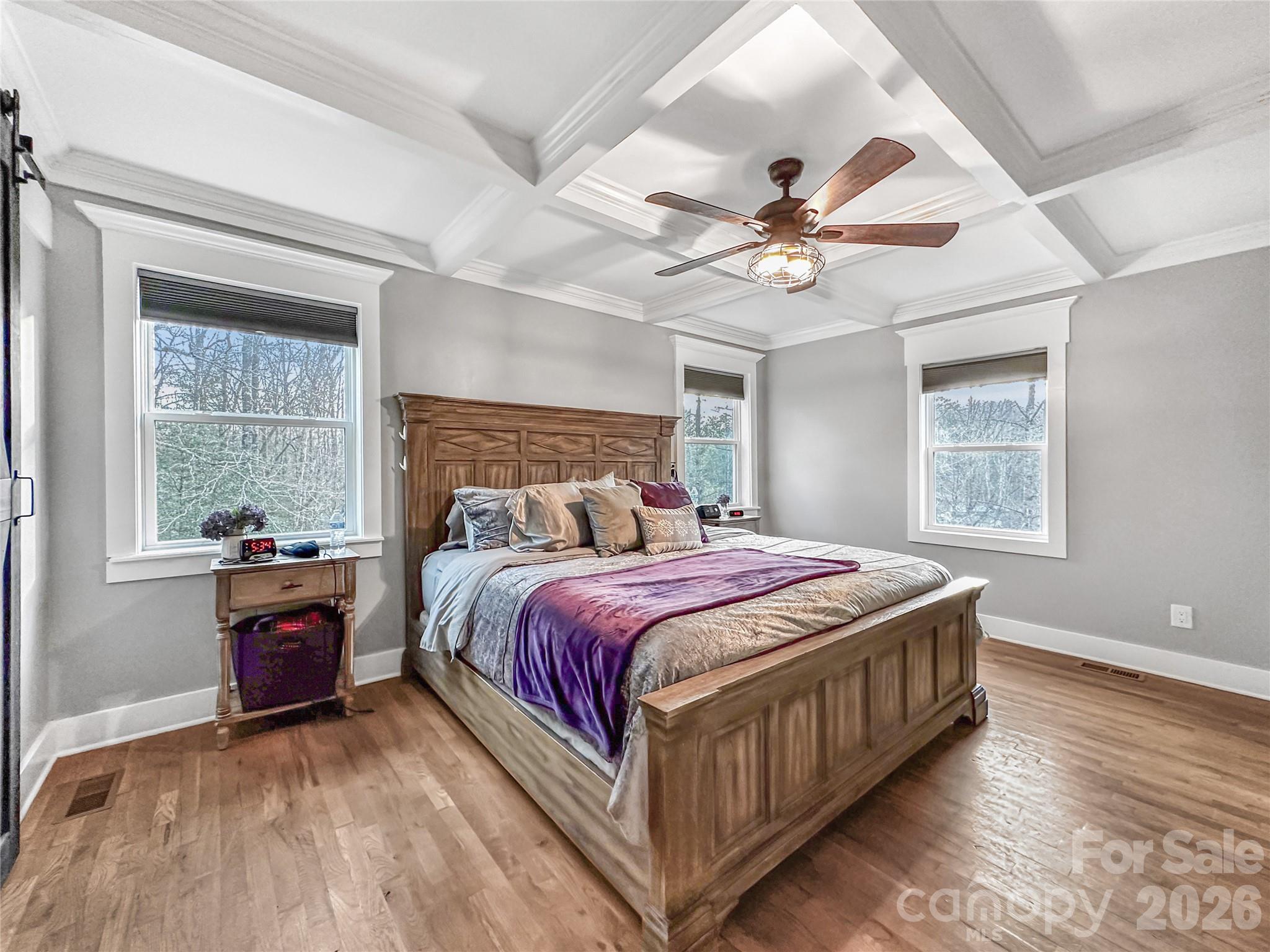 4386 Rocky Road Lenoir, NC 28645 - Photo 16 of 43 a bedroom with a large bed and a chandelier fan