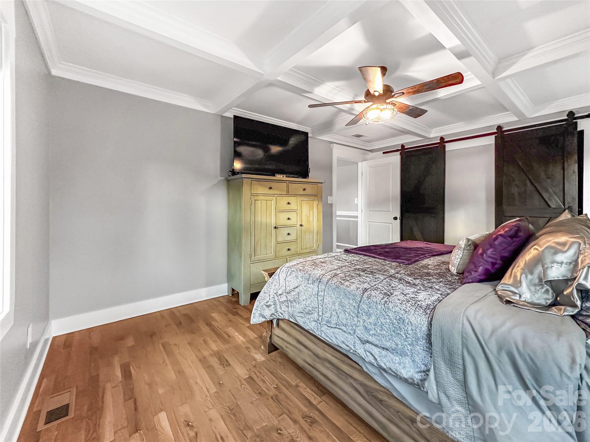 4386 Rocky Road Lenoir, NC 28645 - Photo 17 of 43 a bedroom with a bed and a flat tv screen on dresser