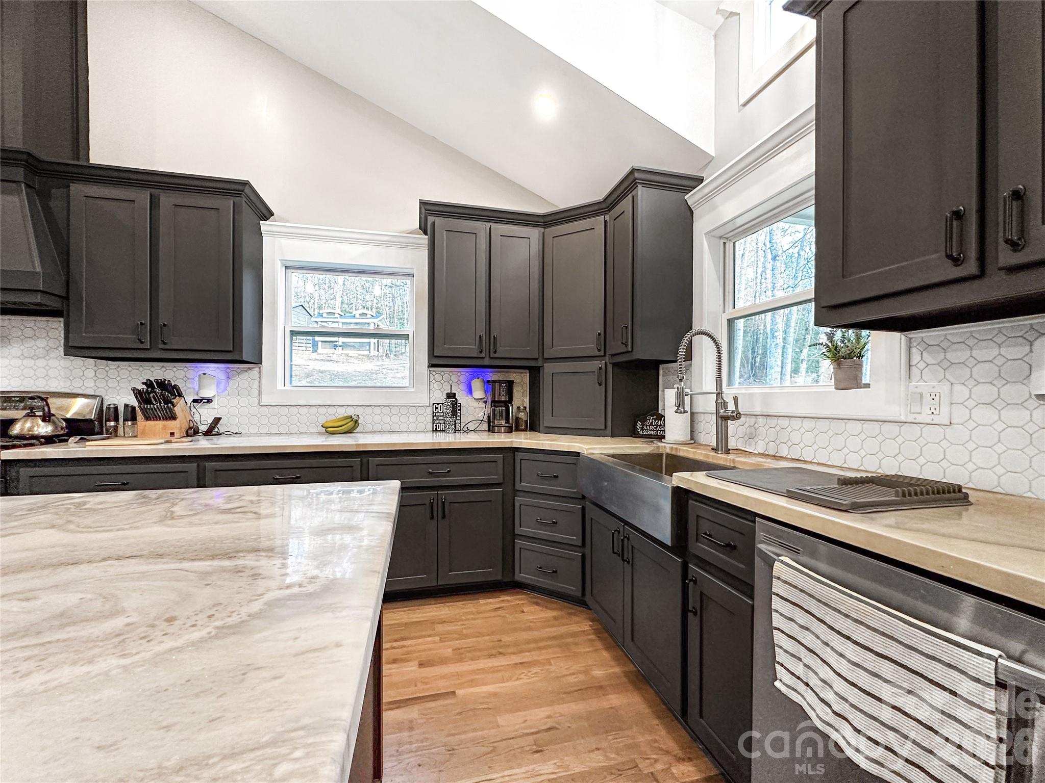4386 Rocky Road Lenoir, NC 28645 - Photo 25 of 43 a kitchen with stainless steel appliances granite countertop a sink stove and cabinets