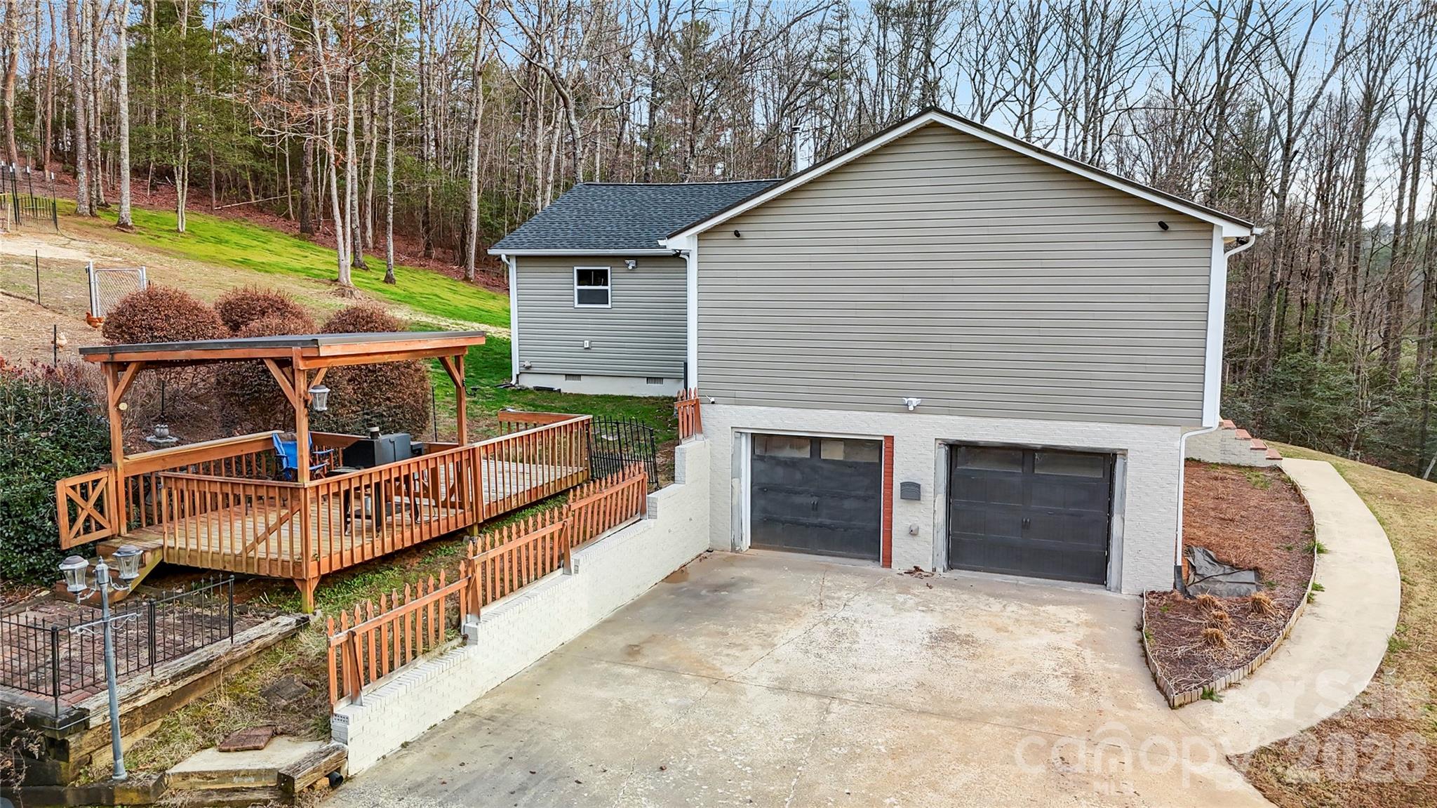 4386 Rocky Road Lenoir, NC 28645 - Photo 8 of 43 a view of a house with a yard chairs and floor to ceiling window