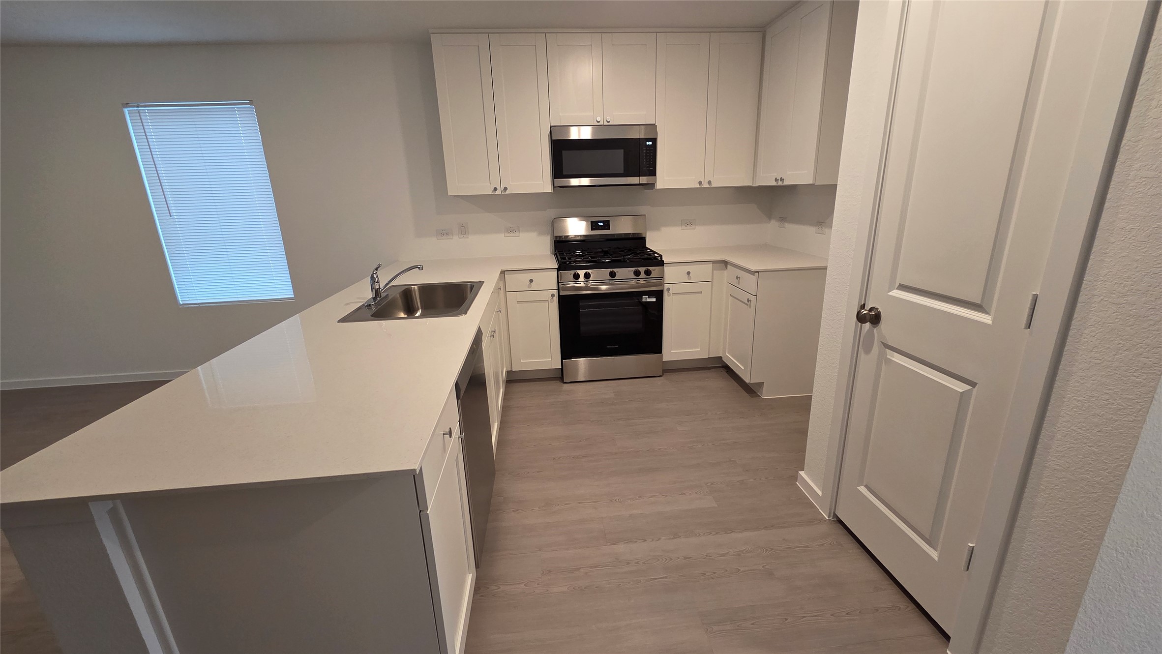 110 Canadian Cove Kyle, TX 78640 - Photo 3 of 20 a kitchen with a refrigerator a stove top oven a sink and dishwasher