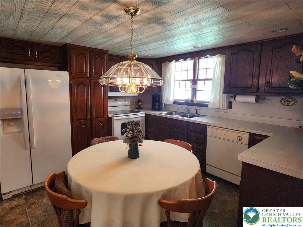 90 Porter Street Nazareth, PA 18064 - Photo 5 of 19 a kitchen with a table chairs a refrigerator and a sink