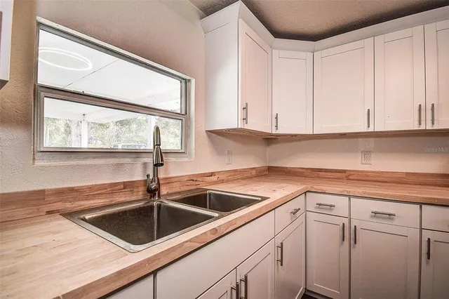 a kitchen with a sink cabinets and window