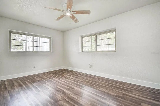 wooden floor in an empty room with a window