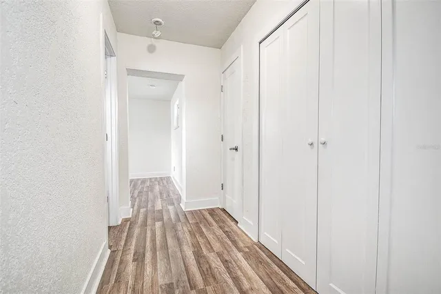 a view of a bathroom with sink and wooden floor