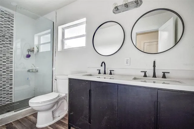 a bathroom with a toilet a sink and a mirror