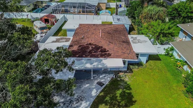 an aerial view of a house with garden space sitting space and swimming pool