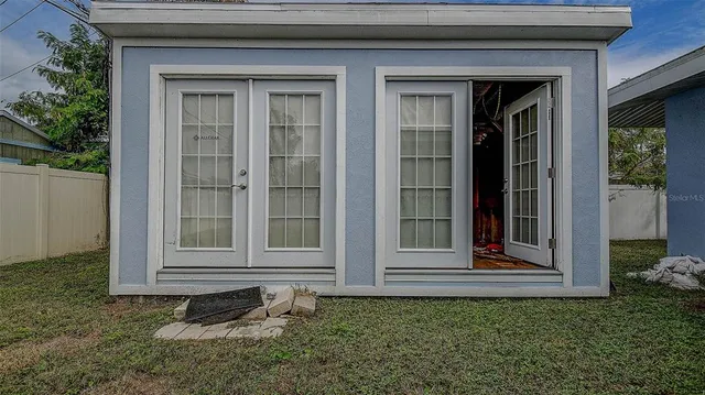 a view of a house with a small backyard