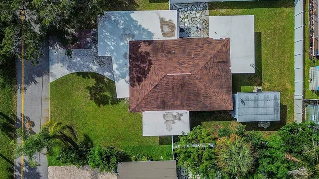 an aerial view of a house with garden space and street view