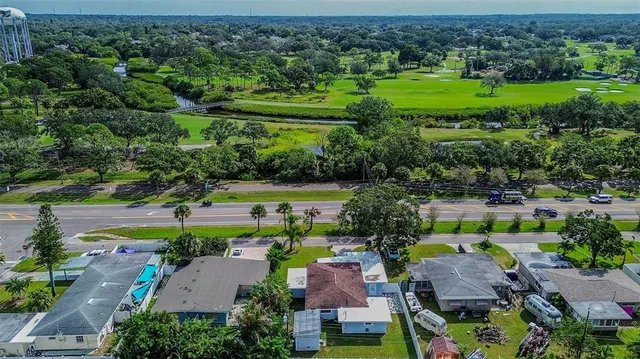 an aerial view of a house with outdoor space swimming pool