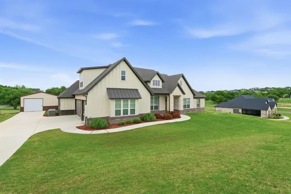 a room with painting on the wall and a potted plant