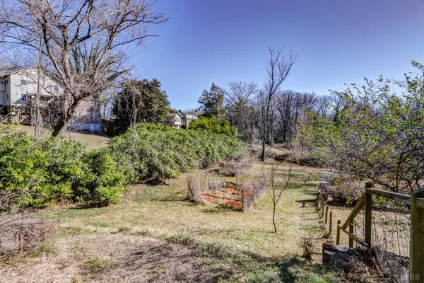 a view of a house with a deck and furniture