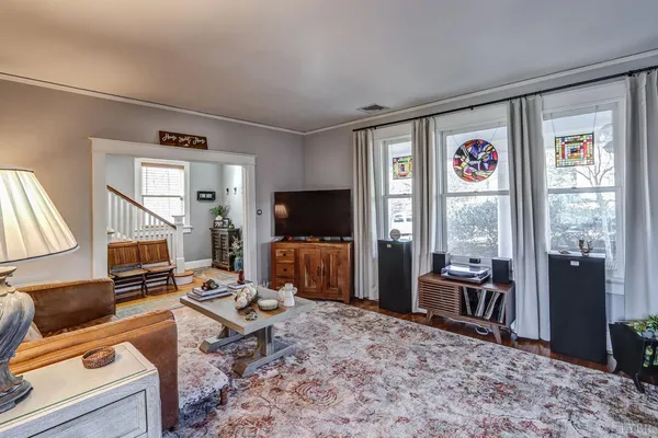 front view of a house with a large window and potted plants