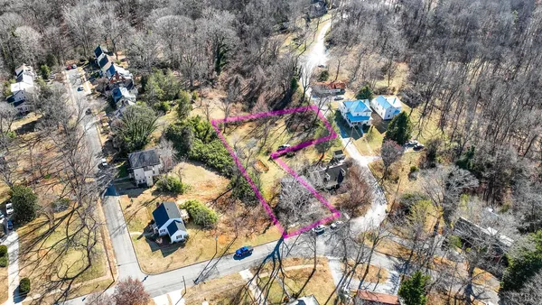 an aerial view of residential houses with city view