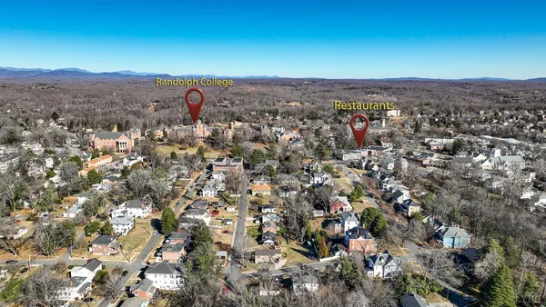 a view of the patio with dining table and chairs under an umbrella