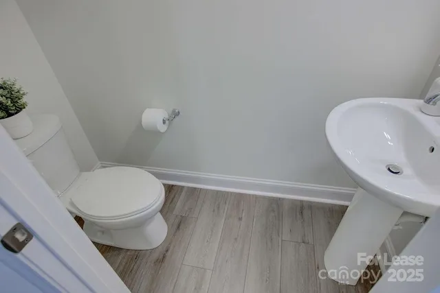a white toilet sitting next to a bathroom sink