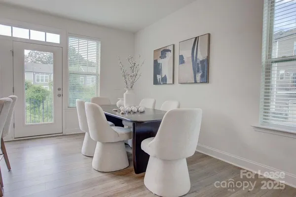 a dining room with furniture and wooden floor
