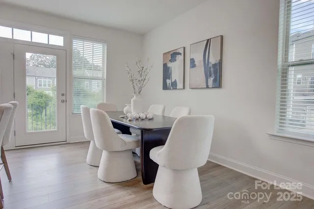 a dining room with furniture and wooden floor