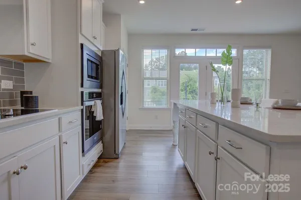 a kitchen with granite countertop a refrigerator and a sink