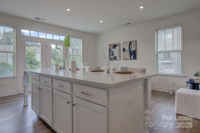 a bathroom with a granite countertop sink mirror and window