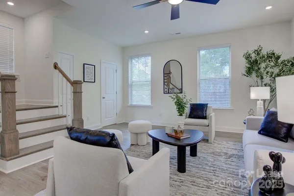 a living room with furniture a potted plant and a fireplace