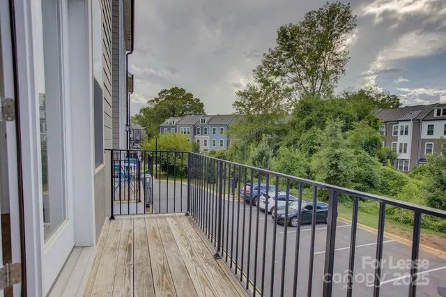 a view of a balcony with wooden floor and fence
