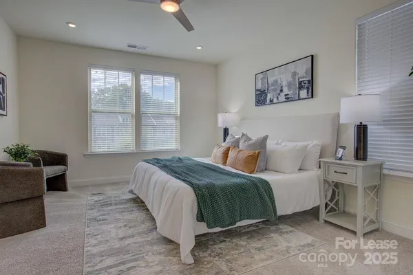 a bedroom with a large bed and a window