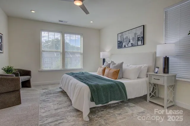 a bedroom with a large bed and a window