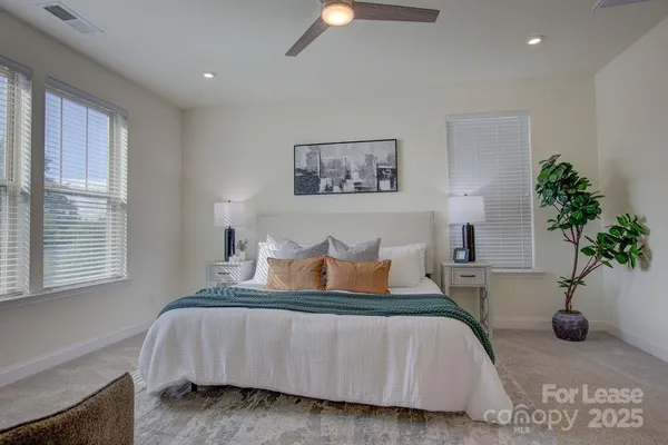a bedroom with bed and a potted plant