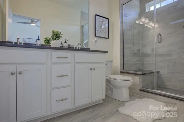 a bathroom with a toilet sink and shower