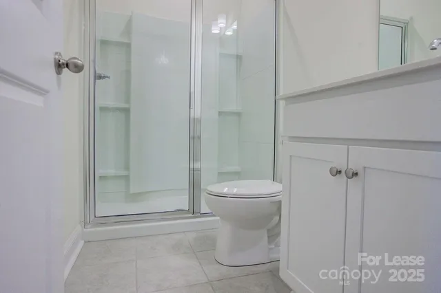 a bathroom with a toilet and shower
