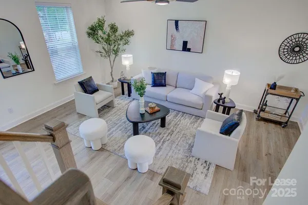 a living room with furniture and wooden floor