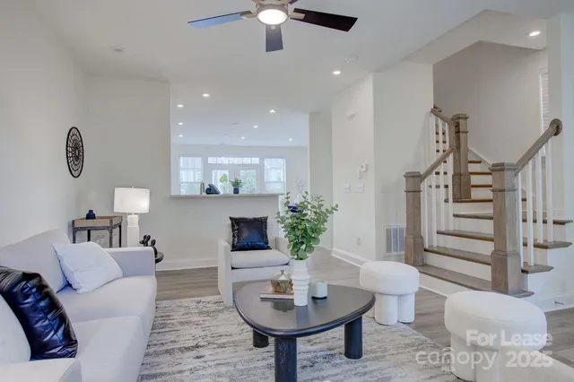 a living room with furniture and a potted plant