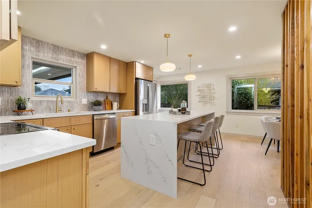 a large kitchen with a table and chairs