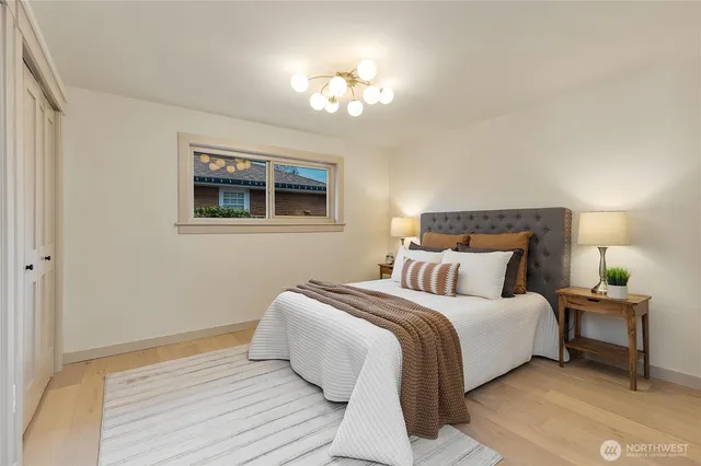 a bedroom with a bed and a chandelier