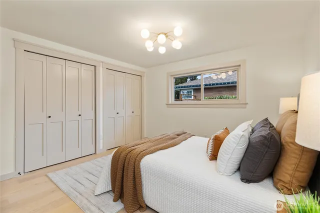 a bedroom with a bed and a chandelier