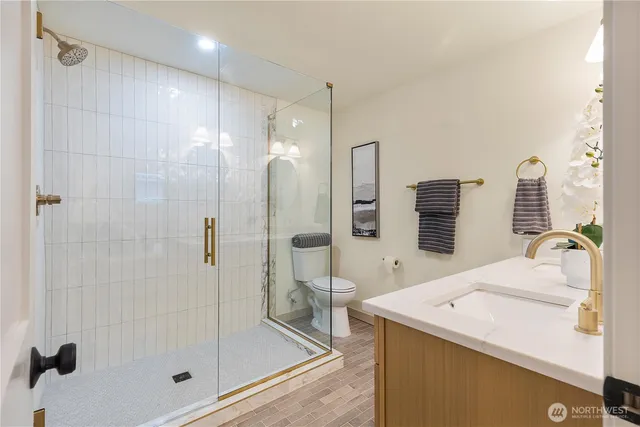 a bathroom with a shower sink and mirror