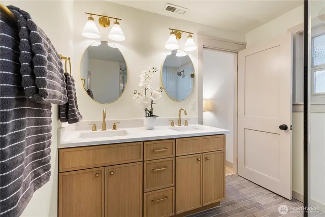 a bathroom with a double vanity sink and a mirror