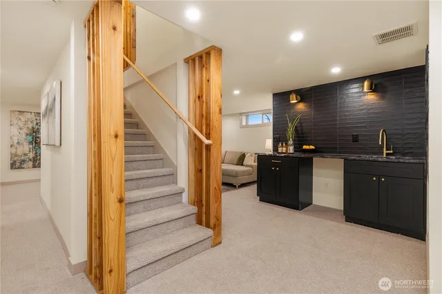 a view of a kitchen with cabinets and black appliances