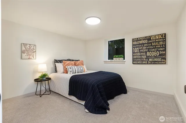 a bedroom with a bed and a large window