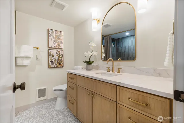 a bathroom with a toilet sink and mirror