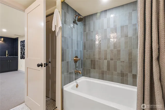 a bathroom with a bathtub and a shower