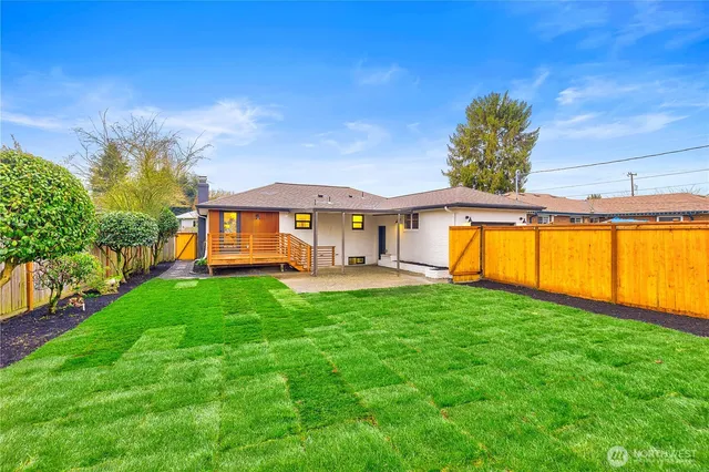 a front view of a house with a yard table and chairs