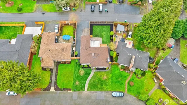 an aerial view of a house with garden space and street view