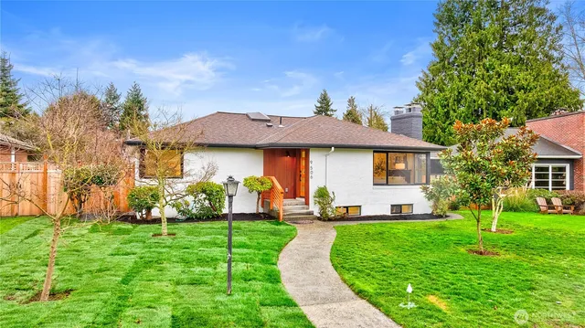 a front view of a house with yard and green space