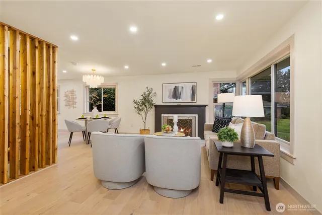 a living room with furniture a fireplace and a window