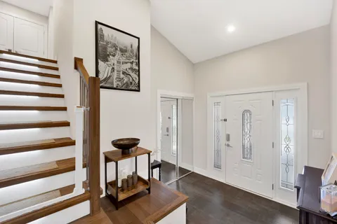 a view of a hallway with wooden floor and windows