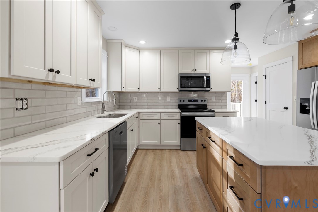 320 Vogel Road Cumberland, VA 23040 - Photo 11 of 28 a kitchen with granite countertop a sink a stove and cabinets
