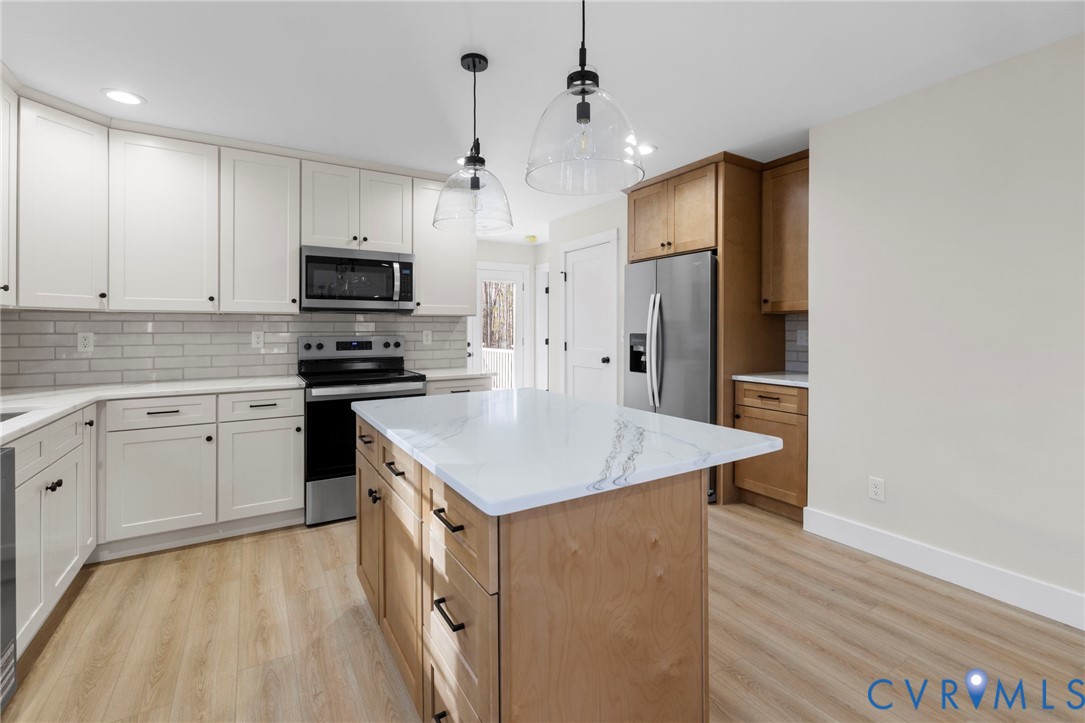 320 Vogel Road Cumberland, VA 23040 - Photo 12 of 28 a kitchen with kitchen island a sink appliances and cabinets